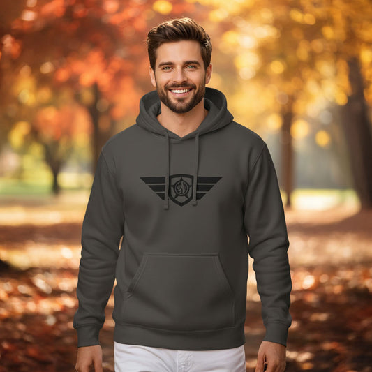 Man wearing HGS Flight Hoodie pigment-dyed Black in an autumn setting