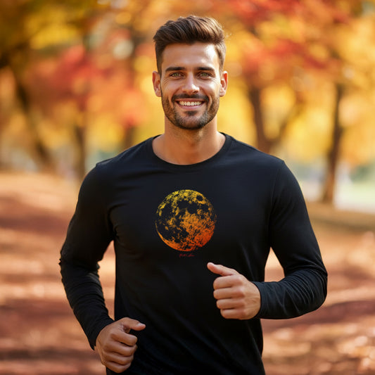 A man wearing an HGS Hunter's Moon black long-sleeve t-shirt with a full moon Graphic outdoors during autumn.