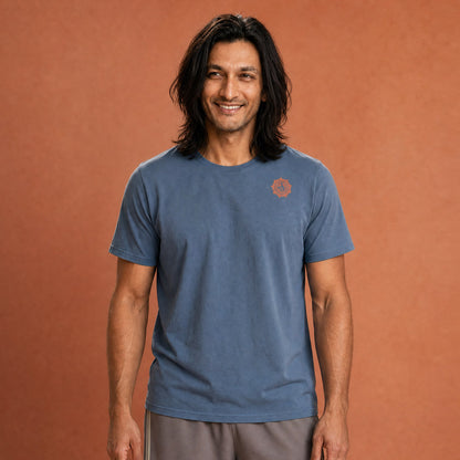 His Good Stuff's Autumn Catalog HGS26S4 Autumn Tee, front, relaxed fit, 100% ring-spun cotton, grey, short-sleeve, on a model against a flat Brandied Melon background. Graphic displays in the top right a small HGS Fall thumbs-up icon