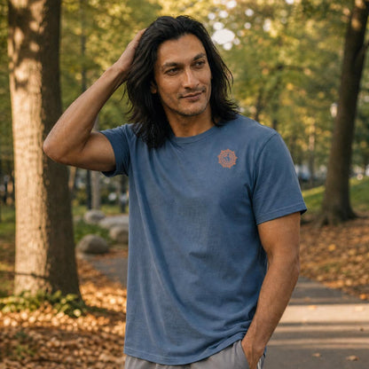 His Good Stuff's Autumn Catalog HGS26S4 Autumn Tee, front, relaxed fit, 100% ring-spun cotton, grey, short-sleeve, on a model walking outside in a city park in the Fall. Graphic displays in the top right a small HGS Fall thumbs-up icon