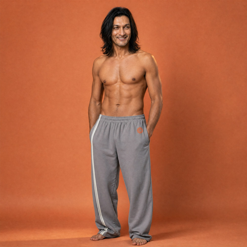 His Good Stuff's Autumn Catalog HGS26S4 Cotton Pants, front, wide-leg, heavyweight cotton-spandex blend, ultimate grey with 2 cloud dancer white stripes, on a model against a flat Brandied Melon background. Graphic displays in the top right a brandied-melon-colored HGS Fall thumbs-up icon.