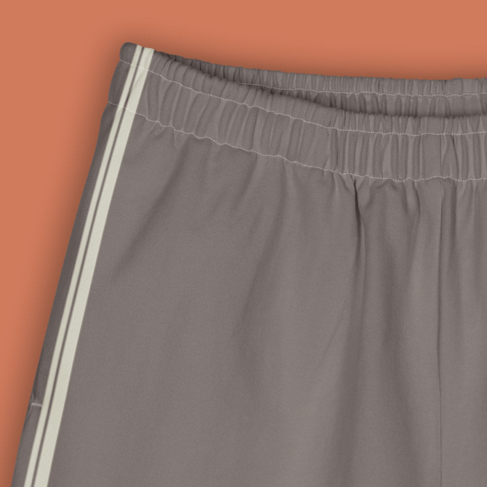His Good Stuff's Autumn Catalog HGS26S4 Cotton Shorts, front detail, Long Shorts, heavyweight cotton-spandex blend, driftwood with 2 light grey stripes, on a model against a flat Brandied Melon background. 