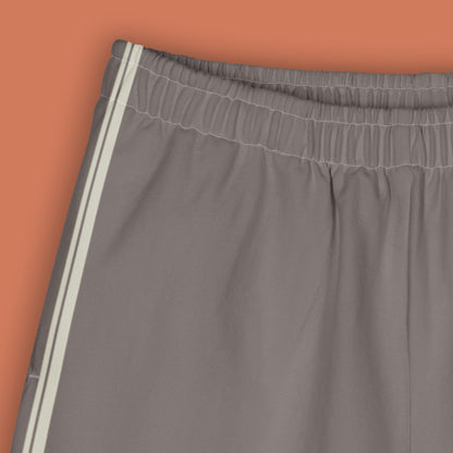 His Good Stuff's Autumn Catalog HGS26S4 Cotton Shorts, front detail, Long Shorts, heavyweight cotton-spandex blend, driftwood with 2 light grey stripes, on a model against a flat Brandied Melon background. 