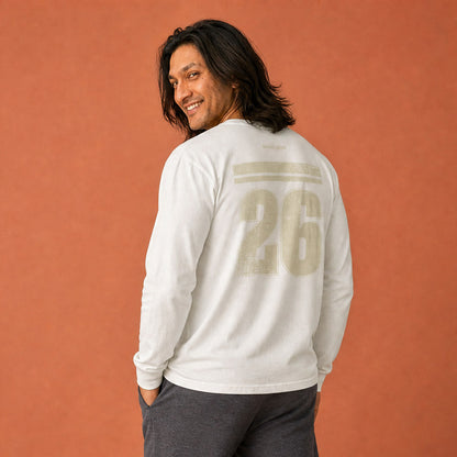 is Good Stuff's Autumn Catalog HGS26S4 Gratitude Jersey, back, heavyweight, 100% ring-spun cotton, white, long-sleeve on model against a flat Brandied Melon background. Graphic displays two bars over a distressed number 26.