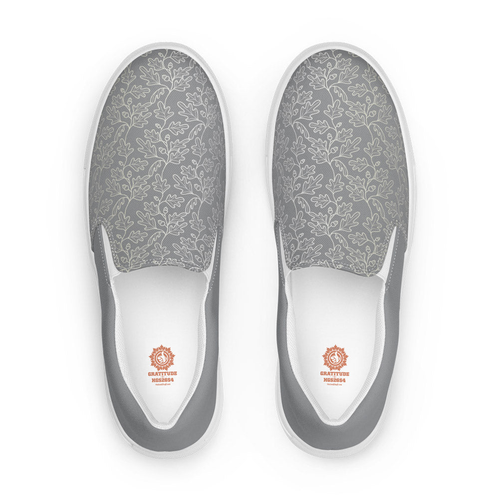His Good Stuff's Autumn Catalog HGS26S4 Slipper Shoes, front view, breathable lining, soft insole, elastic side accents, padded collar and tongue, on a white background. Ultimate Gray with cloud dancer white oak leaf floral pattern over the toes. 