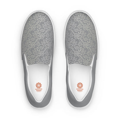 His Good Stuff's Autumn Catalog HGS26S4 Slipper Shoes, front view, breathable lining, soft insole, elastic side accents, padded collar and tongue, on a white background. Ultimate Gray with cloud dancer white oak leaf floral pattern over the toes. 