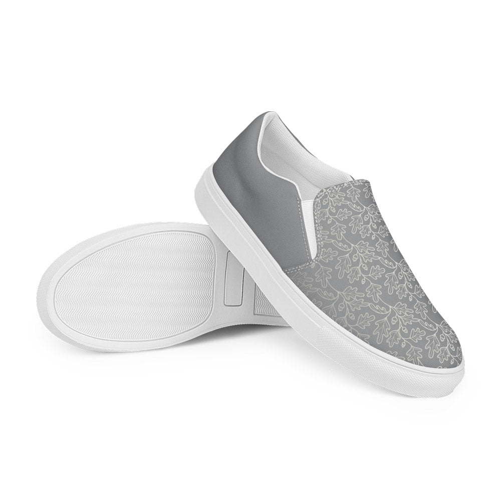 His Good Stuff's Autumn Catalog HGS26S4 Slipper Shoes, stacked view, breathable lining, soft insole, elastic side accents, padded collar and tongue, on a white background. Ultimate Gray with cloud dancer white oak leaf floral pattern over the toes. 