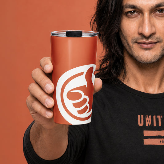 His Good Stuff's Autumn Catalog HGS26S4 Travel Tumbler, front closeup view, 20 oz, glossy stainless steel, vacuum-sealed insulation, with a model against a flat Brandied Melon background. Graphics display a cloud dancer white HGS thumbs-up icon.