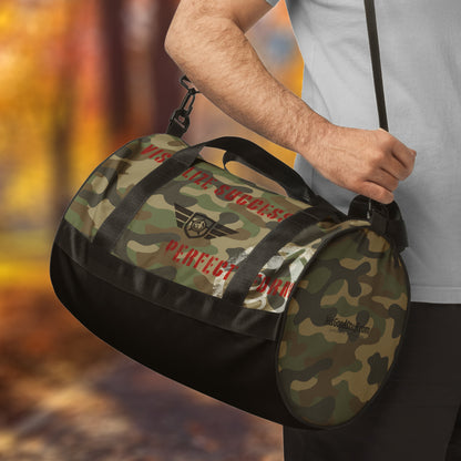 HGS Flight Gym Travel Bag is a Camouflage duffel bag with branding held by a person against a blurred natural background